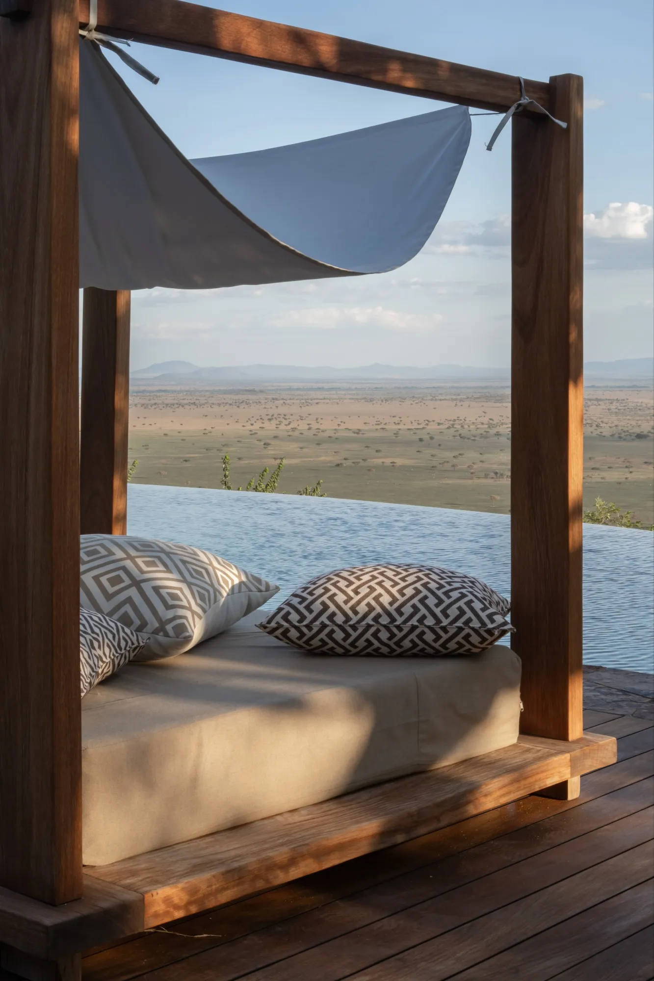 A day bed by the swimming pool at Singita Kilima